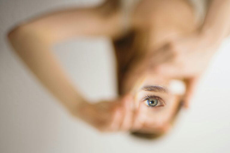 An eye framed by fingers representing insight and the psychology behind persuasive copywriting.